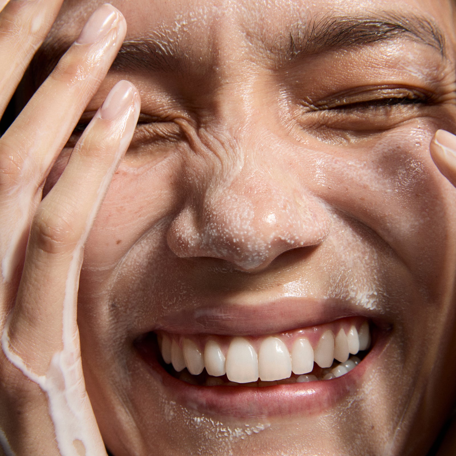 Model cleansing skin with Hydrating Cream-to-Milk Cleanser