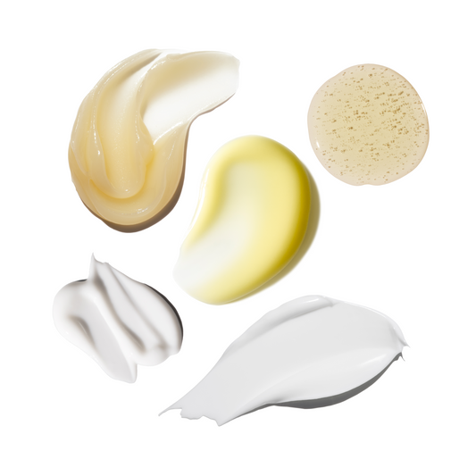 Various swatches of cream and a sponge on a white background