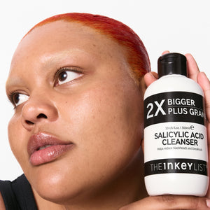 model holding a supersize Salicylic Acid Cleanser