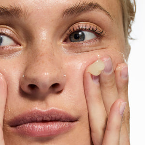 Model applying
Oat Cleansing Balm to her face