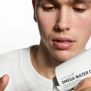 Model applying Omega Water Cream to his finger