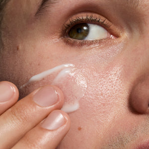 Model applying Omega Water Cream to her face