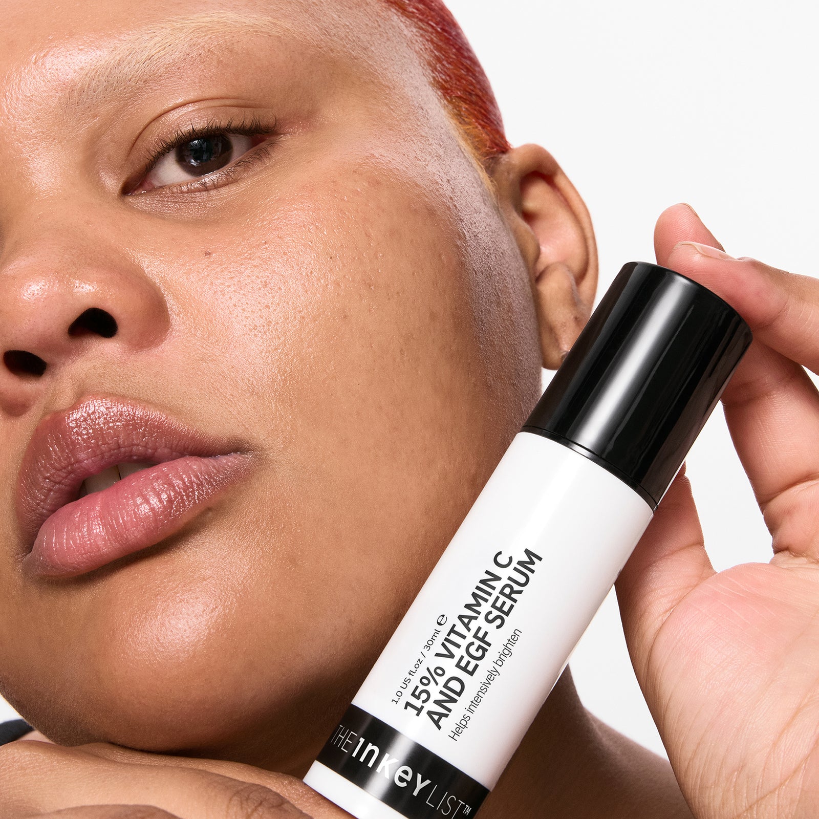 Person holding a 15% Vitamin C + EGF Serumwith a neutral background