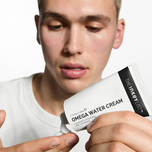 Model applying Omega Water Cream to his finger