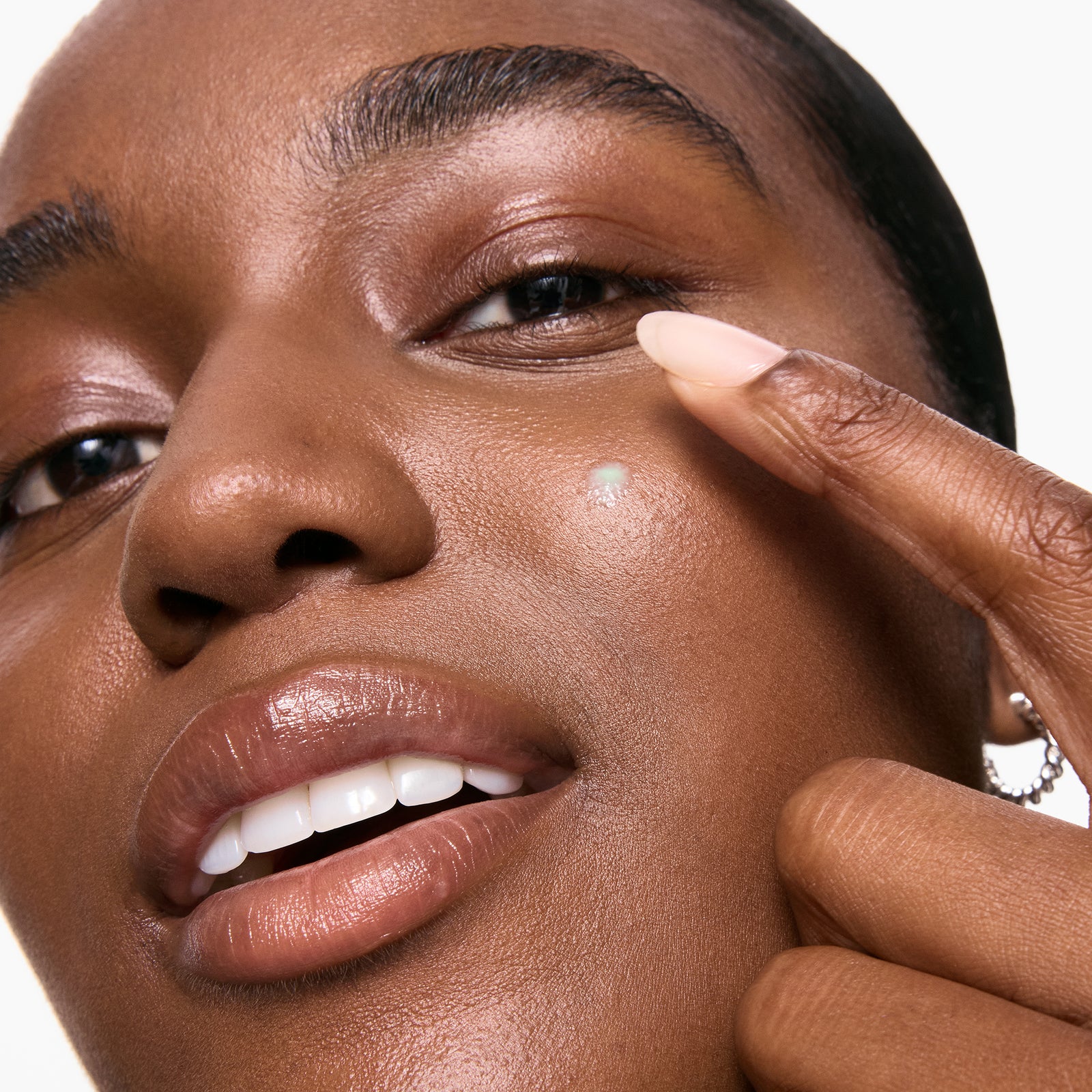 Model applying Succinic Acid Acne Treatment to her face
