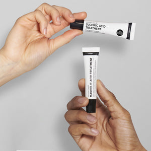 Two hands each holding a product from the Targeted Blemish Duo