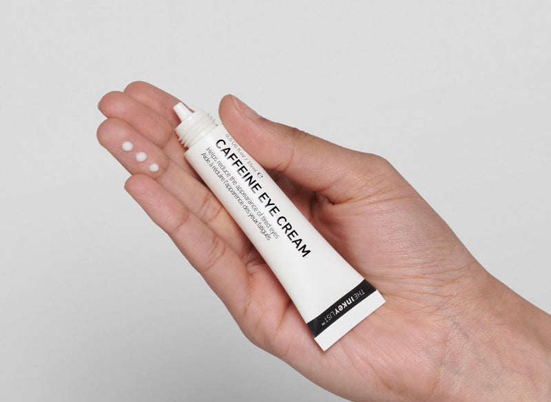 The INKEY List Caffeine Eye Cream squeezed onto model hand