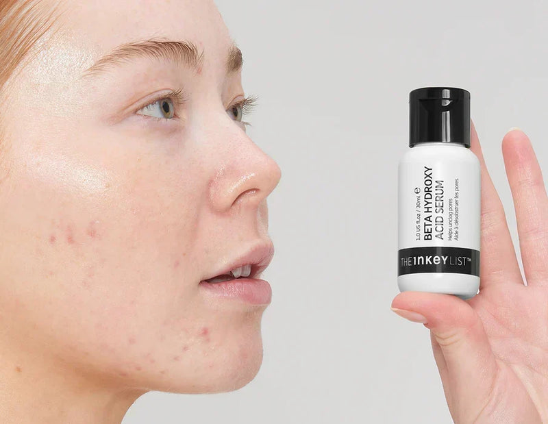 Woman holding BHA serum