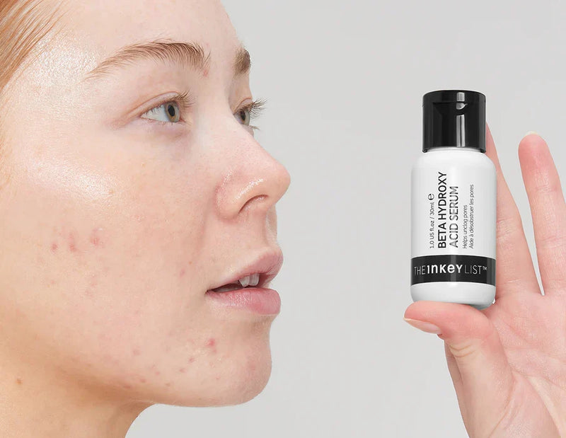 Woman holding BHA serum