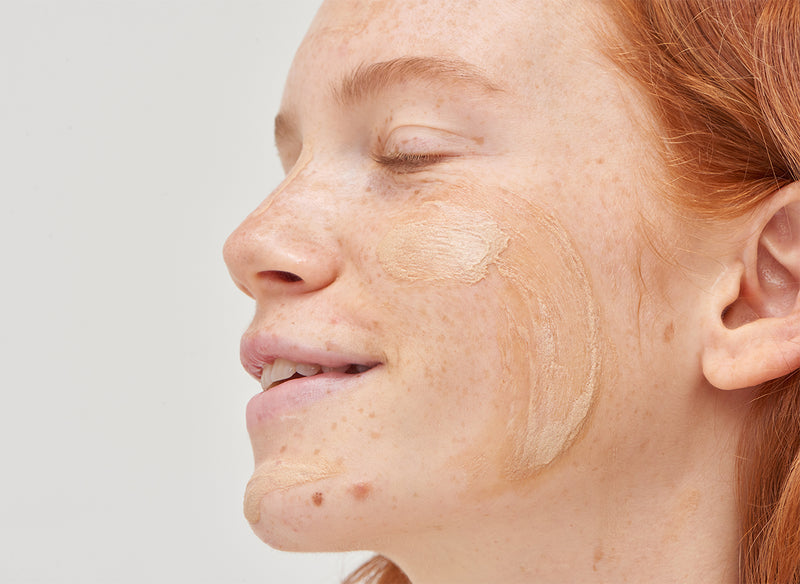 Model with cream on her face