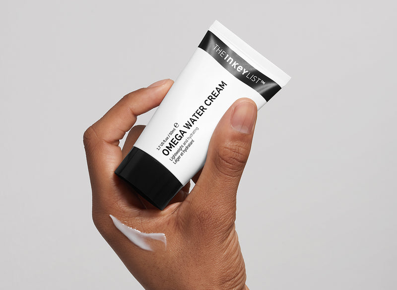 Omega Water Cream held in model's hand
