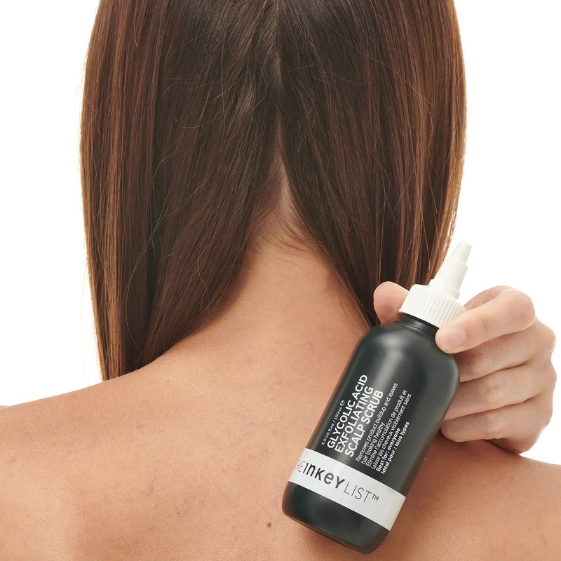 woman holding glycolic scalp scrub