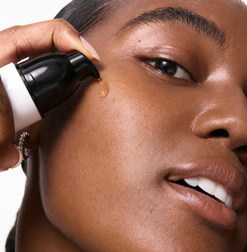 Model using skincare on her face