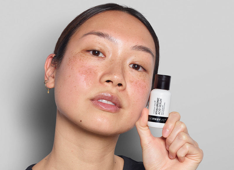 Model smiling with serum 