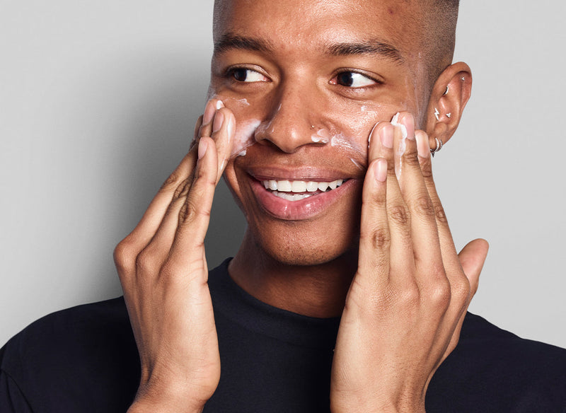 Model rubbing cleanser in his face
