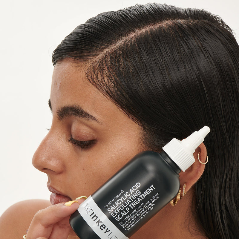 woman holding scalp treatment