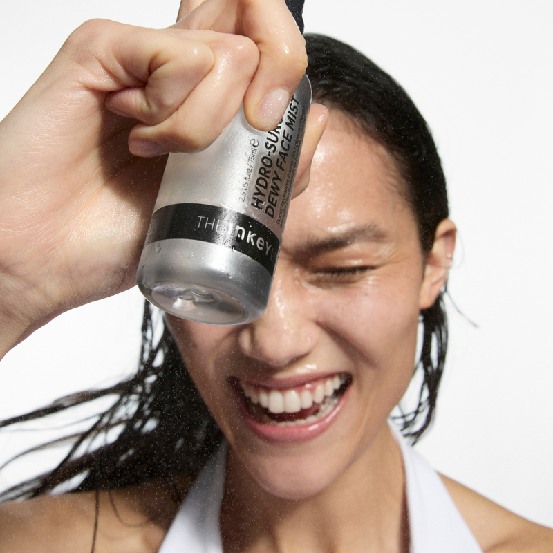 woman applying face mist