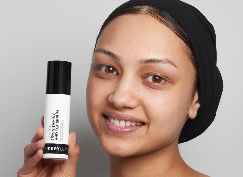 Model holding 15% Vitamin C bottle