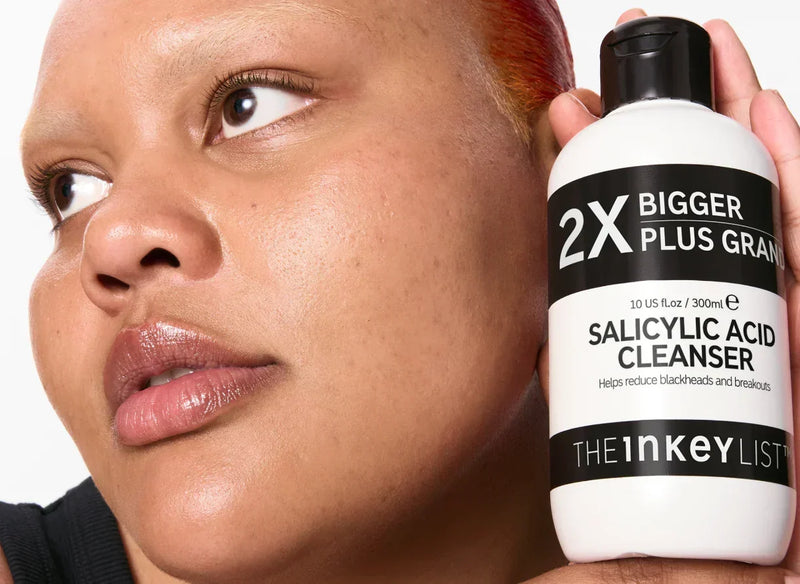 woman with cleanser bottle
