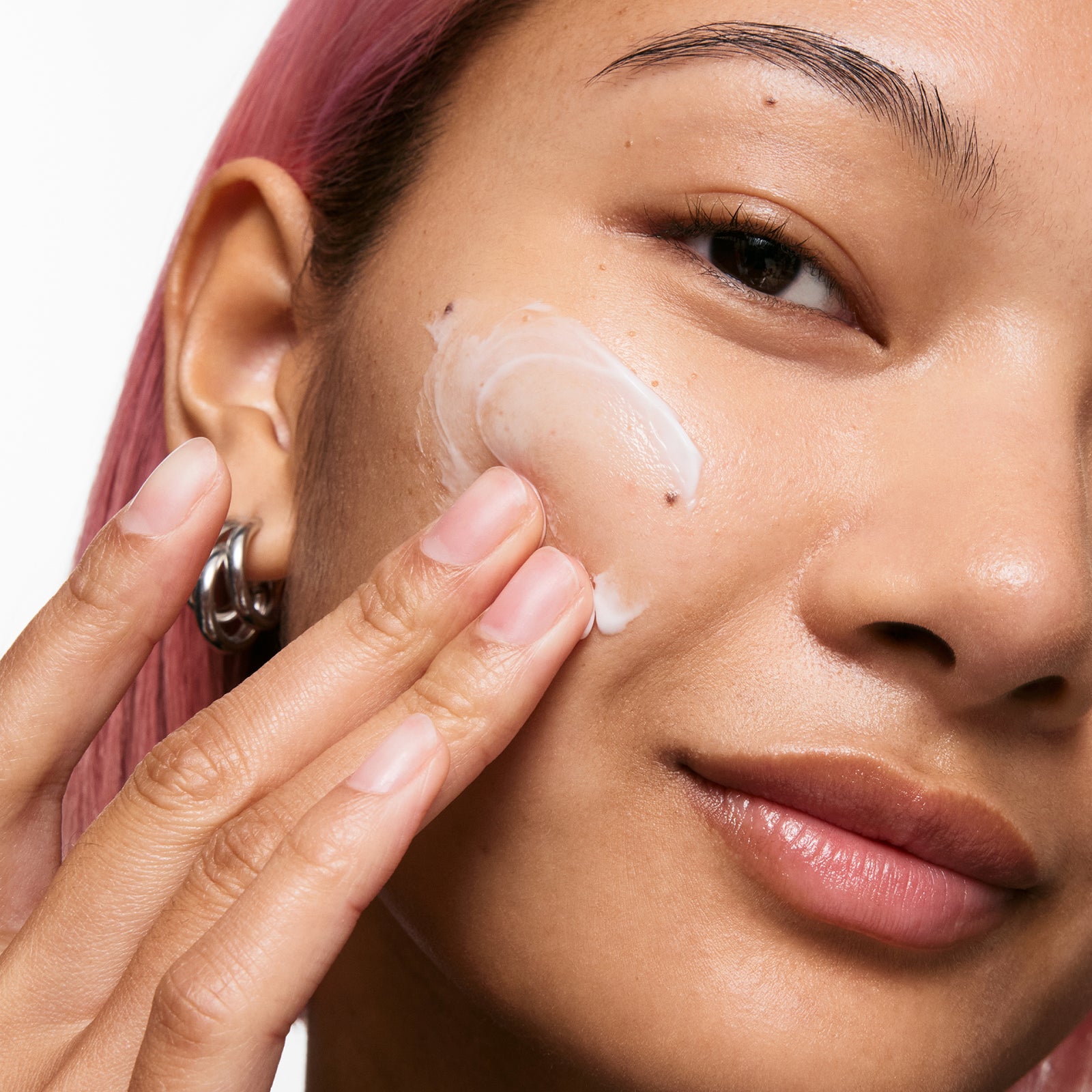 Model applying Bio-Active Ceramide Moisturizer to face