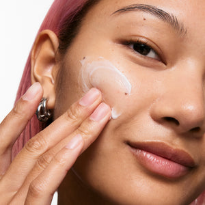 Model applying Bio-Active Ceramide Moisturizer to face