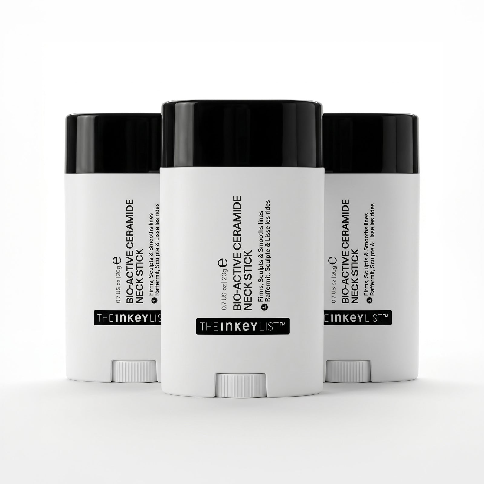 Three white cosmetic sticks with black lids on a white background, featuring 'The Inkey List' branding.