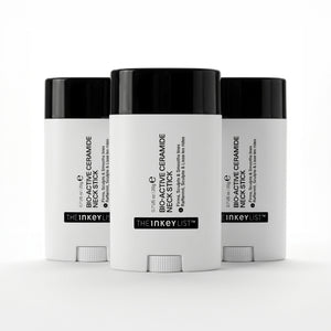Three white cosmetic sticks with black lids on a white background, featuring 'The Inkey List' branding.