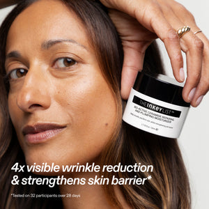 Woman holding a jar of The Inkey List skincare product with text about wrinkle reduction.