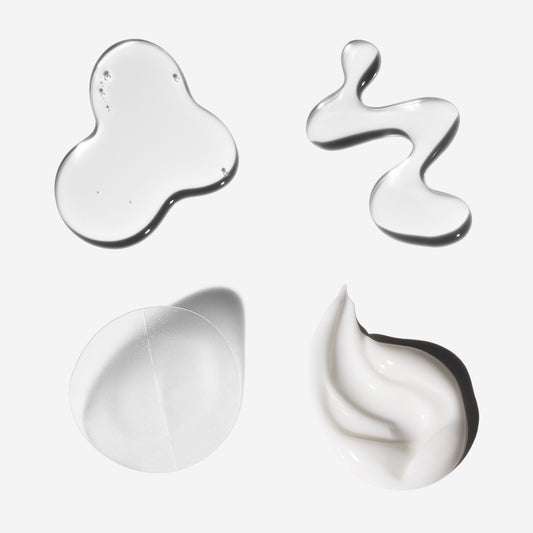 Four different textures of cream on a white background