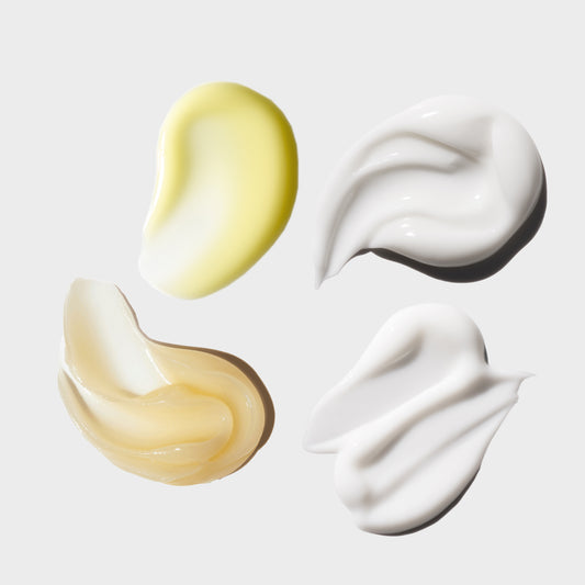 Three swatches of cream in different colors on a light background
