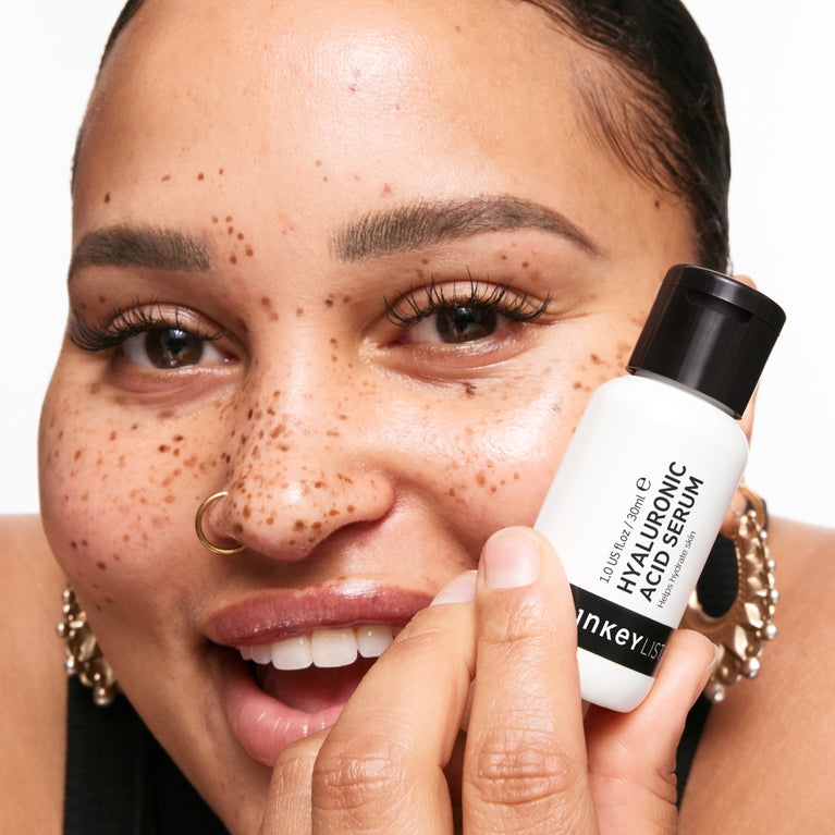 model holding Serum bottle