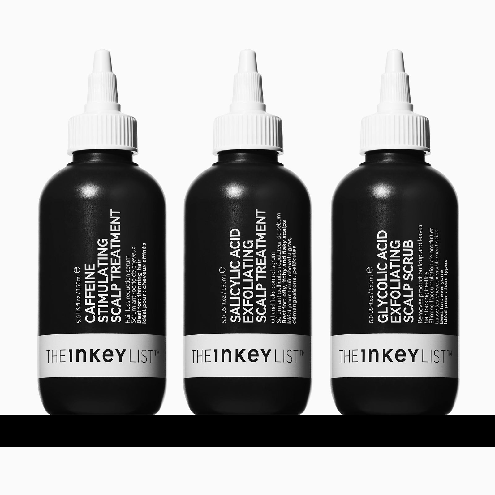 Three black bottles with white caps from The Inkey List on a white background