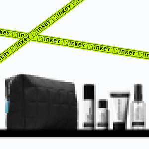 Black makeup bag with Inkey List skincare products on a white background with yellow tape.