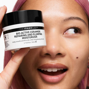Model holding a jar of Bio-Active Ceramide Moisturizer