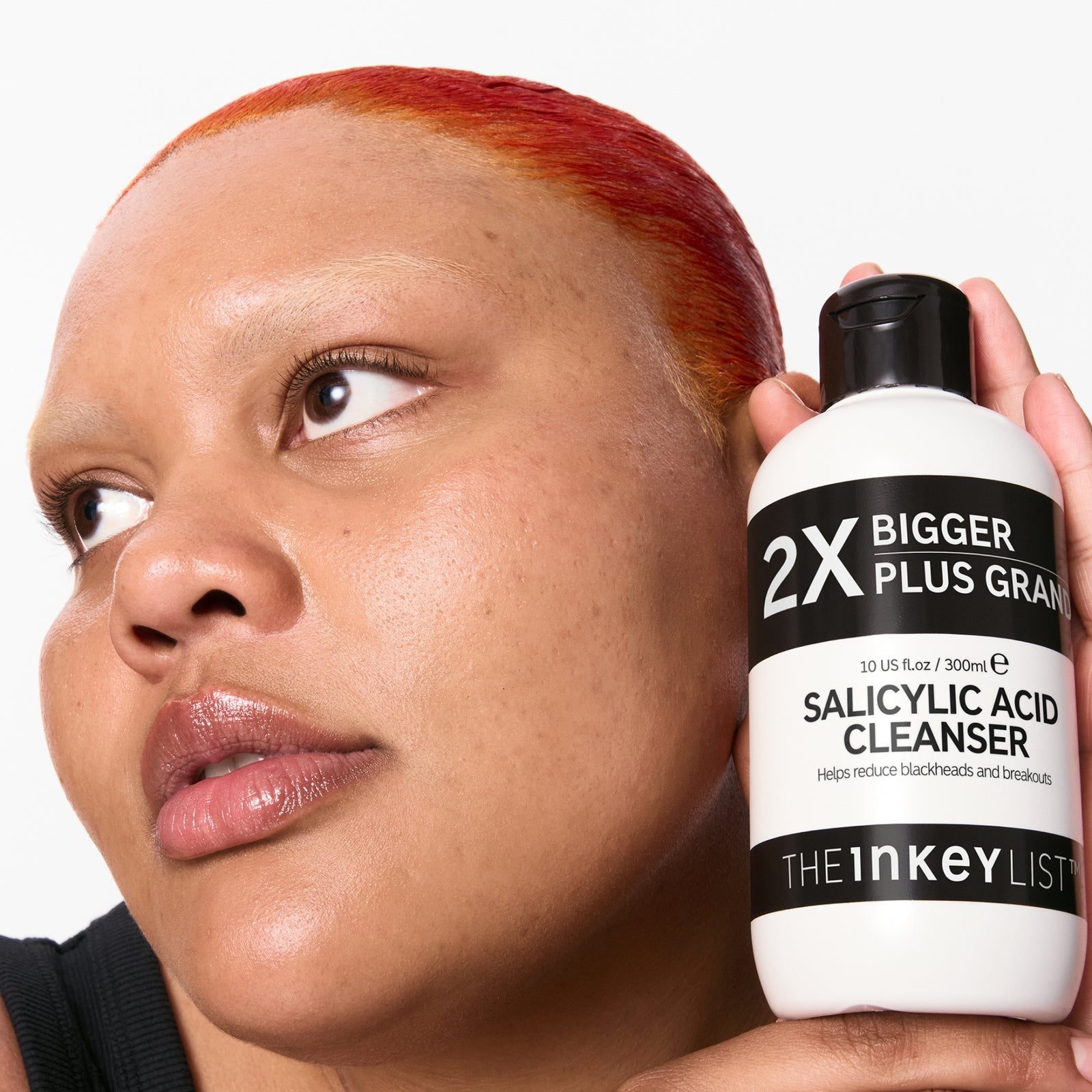 model holding a supersize Salicylic Acid Cleanser