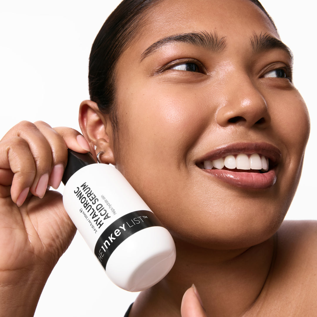 Model holding a Supersize Hyaluronic Acid Serum 100ml