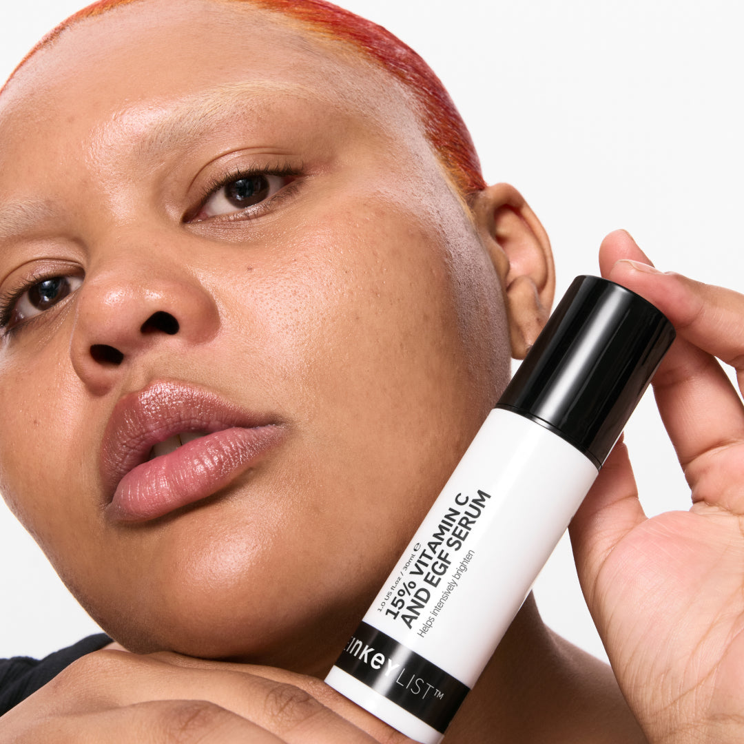 Model holding a bottle of 15% Vitamin C + EGF Serum