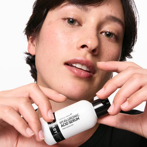 Model holding a bottle of Hyaluronic Acid Serum 60ml
