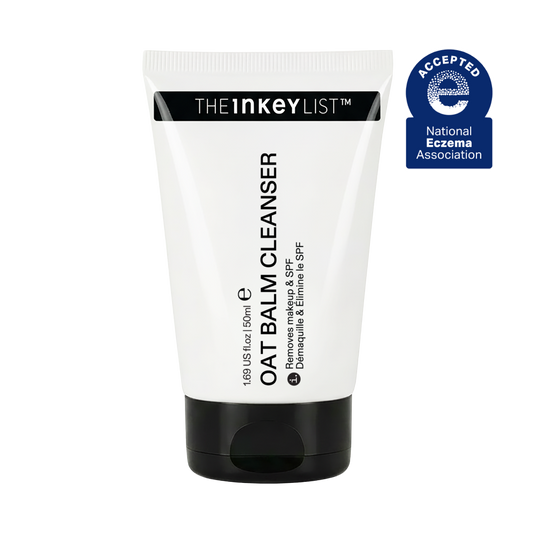 A white squeeze tube of The Inkey List Oat Balm Cleanser with a black cap, shown on a plain white background with a blue National Eczema Association seal in the top right corner.
