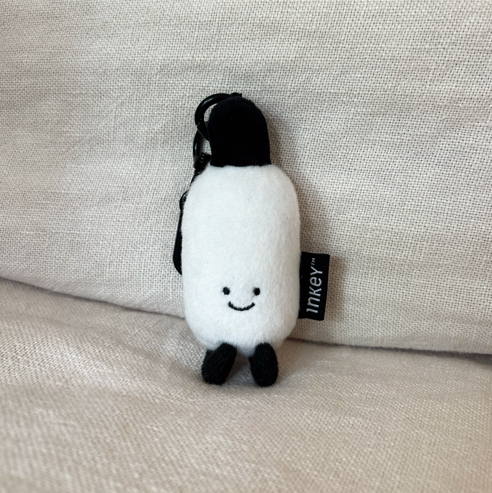 Limited edition Hyaluronic Acid Serum plushie sat on a sofa