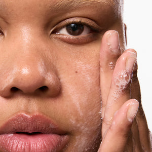 Model using Salicylic Acid Cleanser on her face