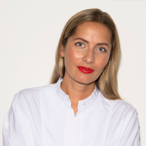 Woman wearing a white shirt against a plain background