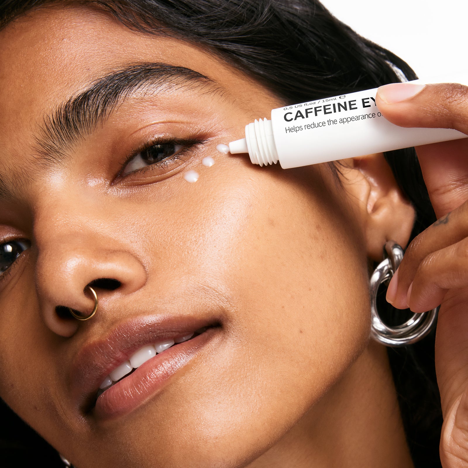 Model applying Caffeine eye Cream