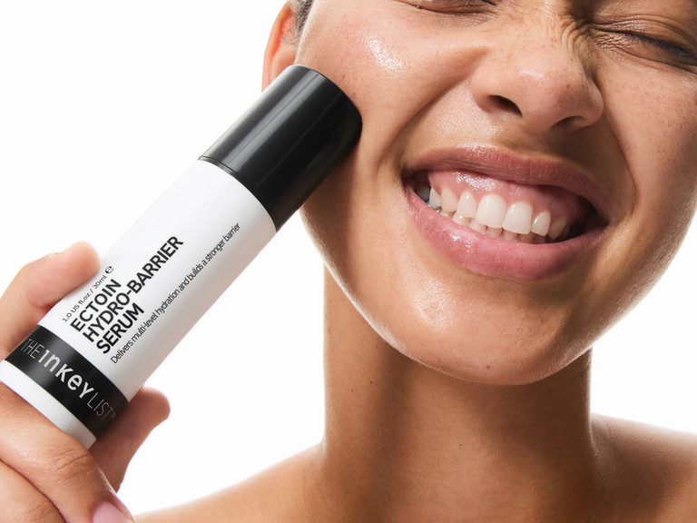 woman holding Ectoin serum