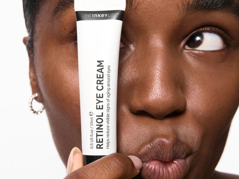 Woman holding Retinol eye cream