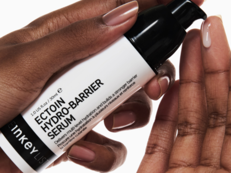 Inkey List Ectoin Hydro-Barrier Serum held by a hand with a white background