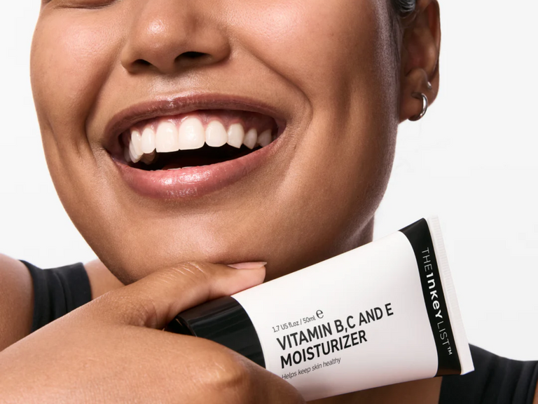 Person holding a tube of The Inkey List Vitamin B,C and E Moisturizer