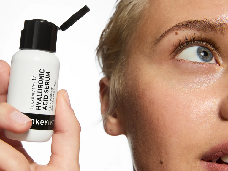Woman holding HA serum
