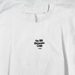 White t-shirt with 'No BS Skincare Club' text on a white background