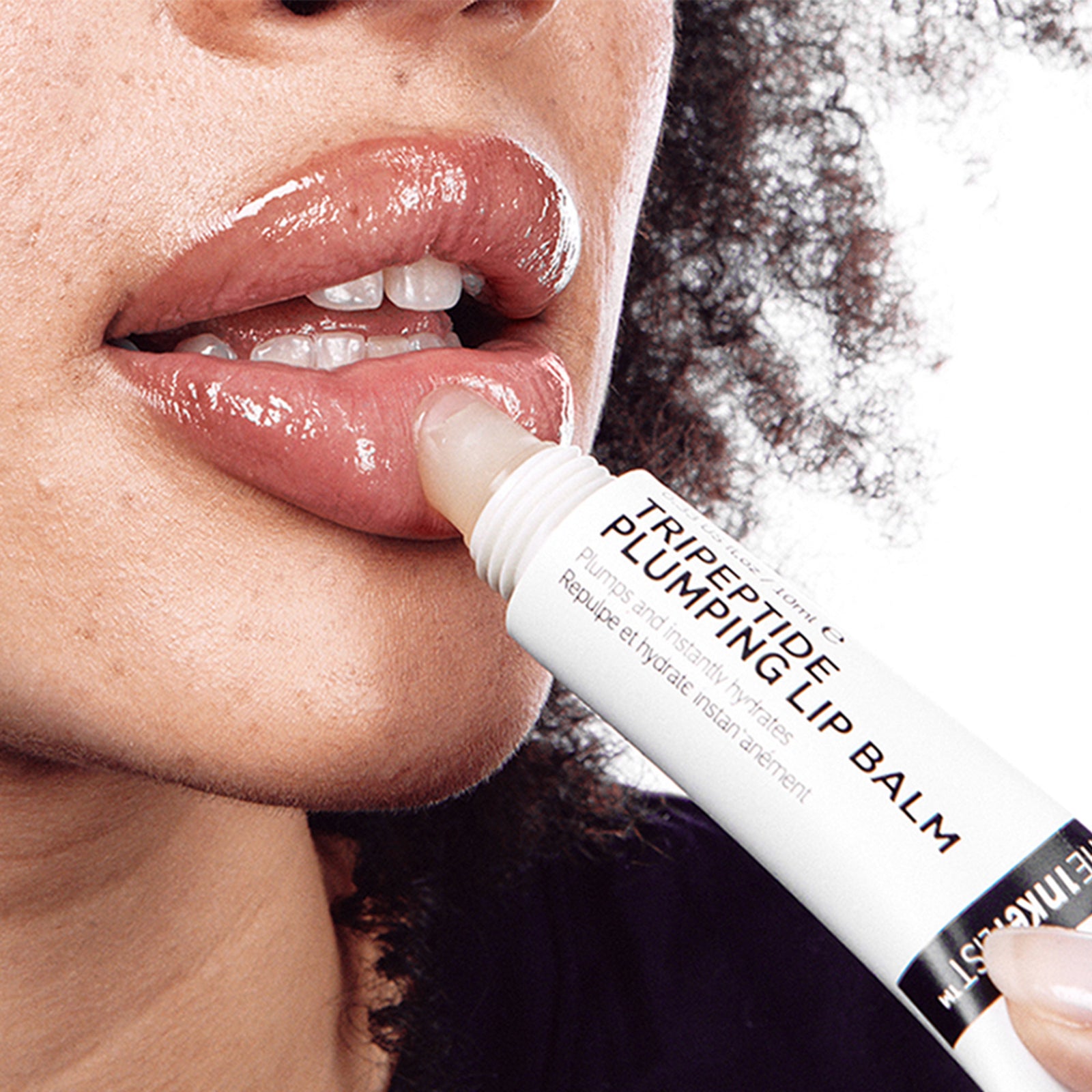 Model applying Tripeptide Plumping Lip Balm